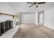 Cozy living room with a brick fireplace, neutral carpet, and a ceiling fan for added comfort at 2391 66Th S Ter, St Petersburg, FL 33712