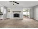 Inviting living room featuring a white brick fireplace, neutral walls, and access to a screened-in porch at 2391 66Th S Ter, St Petersburg, FL 33712