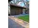 Quaint outdoor patio area with brick pavers, seating, and lush landscaping at 3010 County Road 31, Clearwater, FL 33759