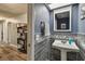 Small bathroom featuring sink with a blue accent wall and gray tile at 4502 Southampton Ct # 4502, Tampa, FL 33618