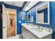 Bathroom featuring a gray vanity with double sinks and bright blue walls at 4502 Southampton Ct # 4502, Tampa, FL 33618