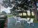 Outdoor community patio and seating area offers a tranquil spot to enjoy nature at 821 Deleon Ct # 108, Dunedin, FL 34698