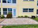 Outdoor patio with brick pavers and lush green grass at 821 Deleon Ct # 108, Dunedin, FL 34698