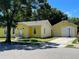 Yellow house with a large detached garage at 2734 53Rd N Ave, St Petersburg, FL 33714