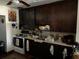 Galley kitchen with dark wood cabinets at 5634 5Th N Ave, St Petersburg, FL 33710