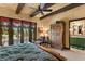 Large bedroom with wooden beams, king bed, and en-suite bathroom at 33642 Blanton Rd, Dade City, FL 33523