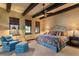 Spacious bedroom with wooden beams, king bed, and sitting area at 33642 Blanton Rd, Dade City, FL 33523