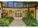 Ornate iron gate entrance with lush landscaping and stone pathway at 33642 Blanton Rd, Dade City, FL 33523