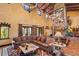 Spacious living room with large stone fireplace, high ceilings, and comfortable seating at 33642 Blanton Rd, Dade City, FL 33523