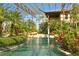 Expansive pool with covered patio and tropical landscaping at 33642 Blanton Rd, Dade City, FL 33523