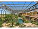 Luxurious pool and patio area with covered cabana, lush landscaping, and stunning views at 33642 Blanton Rd, Dade City, FL 33523