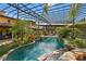 Relaxing pool area with a covered patio and tropical landscaping at 33642 Blanton Rd, Dade City, FL 33523