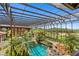 Enclosed pool area with lush landscaping and a waterfall feature at 33642 Blanton Rd, Dade City, FL 33523