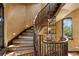 Elegant spiral staircase with ornate wooden railing and detailed tile work at 33642 Blanton Rd, Dade City, FL 33523