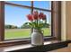 Charming window view showcasing a vase of tulips and a picturesque landscape at 33642 Blanton Rd, Dade City, FL 33523