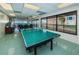 Spacious game room featuring a ping pong table and large windows with scenic views at 622 Edgewater Dr # 822, Dunedin, FL 34698