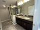 Bathroom with double vanity, granite countertop, and shower at 11468 Weaver Hollow Rd, New Port Richey, FL 34654