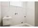 Laundry room with utility sink, shelving, and neutral-colored walls at 11468 Weaver Hollow Rd, New Port Richey, FL 34654