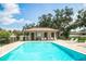 Community pool with lounge chairs and a shaded seating area at 11468 Weaver Hollow Rd, New Port Richey, FL 34654