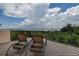 Relaxing balcony with water views and comfortable lounge chairs at 109 Wateredge Ct, Safety Harbor, FL 34695