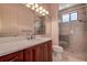 Bathroom with a quartz vanity, large mirror, and a glass shower at 109 Wateredge Ct, Safety Harbor, FL 34695