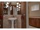 Elegant bathroom with pedestal sink, decorative tile, and a large mirror at 109 Wateredge Ct, Safety Harbor, FL 34695