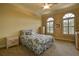 Bright bedroom with a floral comforter and arched windows at 109 Wateredge Ct, Safety Harbor, FL 34695