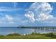 Wooden pier extending into calm waters under a partly cloudy sky at 109 Wateredge Ct, Safety Harbor, FL 34695