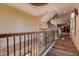 Upstairs hallway with wood floors, iron railing, and decorative wall at 109 Wateredge Ct, Safety Harbor, FL 34695