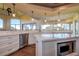 Open kitchen with white cabinetry, quartz countertops, and hardwood floors at 109 Wateredge Ct, Safety Harbor, FL 34695