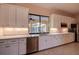 Modern kitchen with white cabinets, stainless steel appliances, and quartz countertops at 109 Wateredge Ct, Safety Harbor, FL 34695