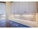 Bright kitchen with white cabinets, quartz countertops, and under cabinet lighting at 109 Wateredge Ct, Safety Harbor, FL 34695