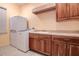 Laundry room with washer, dryer, sink, and ample wood cabinets at 109 Wateredge Ct, Safety Harbor, FL 34695