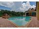 Inviting pool with a covered patio and lush landscaping at 109 Wateredge Ct, Safety Harbor, FL 34695