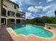 Large, freeform swimming pool with a brick patio at 109 Wateredge Ct, Safety Harbor, FL 34695