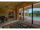 View of the pool area from inside the house, showing a lounge chair and brick patio at 109 Wateredge Ct, Safety Harbor, FL 34695