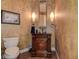 Stylish powder room with dark wood vanity and decorative mirror at 109 Wateredge Ct, Safety Harbor, FL 34695