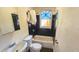 Bathroom featuring dark tile, a tub with shower, and a vanity, providing a functional and modern space at 1414 7Th S St, St Petersburg, FL 33701