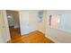 Cozy bedroom with hardwood floors, a white door, and a window allowing natural light to illuminate the room at 1414 7Th S St, St Petersburg, FL 33701
