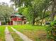 Red two-story house with a grassy yard and driveway at 1414 7Th S St, St Petersburg, FL 33701