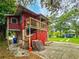 Side view of a charming red house with a balcony at 1414 7Th S St, St Petersburg, FL 33701