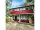 Front view of red house with small yard at 1414 7Th S St, St Petersburg, FL 33701