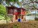 Back view of red house with large tree cover at 1414 7Th S St, St Petersburg, FL 33701