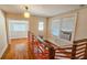 Hallway with hardwood floors, a wooden railing and a window air conditioning unit at 1414 7Th S St, St Petersburg, FL 33701