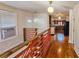 Hallway with hardwood floors, a wooden railing, and a view into the kitchen at 1414 7Th S St, St Petersburg, FL 33701