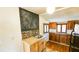 Kitchen area with stainless sink, tiled backsplash, chalkboard paint, and wood cabinets, creating a functional and stylish space at 1414 7Th S St, St Petersburg, FL 33701