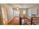 Wooden staircase with landing, bathed in natural light from windows, creating an inviting transitional space within the home at 1414 7Th S St, St Petersburg, FL 33701