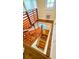 Wooden staircase with railing leads to the next level, bathed in natural light from multiple windows at 1414 7Th S St, St Petersburg, FL 33701