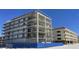 Modern building under construction, near other structures at 14046 Gulf Blvd # 1, Madeira Beach, FL 33708