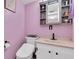 Updated bathroom with pink walls and a modern vanity at 11485 Oakhurst Rd # 221, Largo, FL 33774